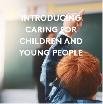 A head and shoulders picture of a young person with their hand up