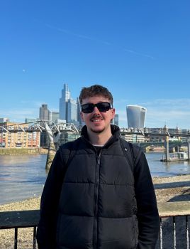 A photo of Oscar (Business and Management BSc) standing in front of the Thames river