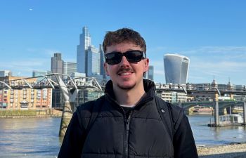 A photo of Oscar (Business and Management BSc) standing in front of the Thames river