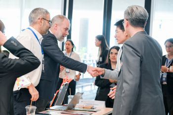 Peter Boddy & Prof Robin Banerjee greeting Mahidol colleagues
