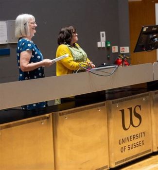 Jo Tregenza is standing to the right of Debra Myhill, an Education Professor at the University of Exeter, who was part of Jo's group advising the BBC.
