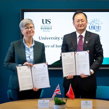 The Sussex Vice-Chancellor and President of UIBE hold up formal agreements that they have signed on behalf of Sussex and UIBE