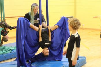 Child participating in circus skills