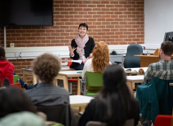Speaker addressing participants at a workshop.