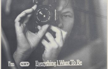 Woman holding camera to face to take photo