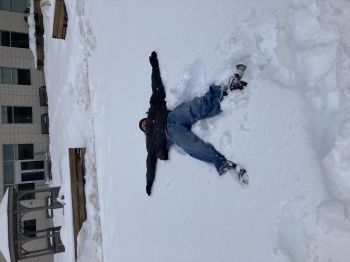 Nancy laying in deep snow