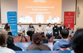 A panel a alumni speakers facing a lecture theatre