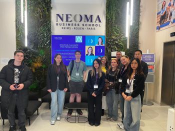 Students standing in a group at a business school in Paris