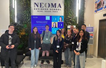 Students standing in a group at a business school in Paris