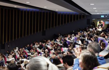A packed auditorium of attendees in a Sussex lecture theatre
