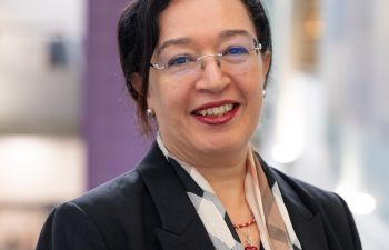 Head shot of smiling woman with black hair