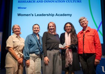 Prof Maria Fasli, Prof Erika Mancini, Katy Stoddard, Dr Elizabeth Rendon-Morales and VC Sasha Roseneil on stage for the Women's Leadership Academy award.