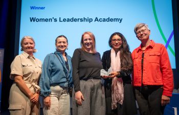 Prof Maria Fasli, Prof Erika Mancini, Katy Stoddard, Dr Elizabeth Rendon-Morales and VC Sasha Roseneil on stage for the Women's Leadership Academy award.