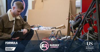 A student working on some technical equipment in a workshop