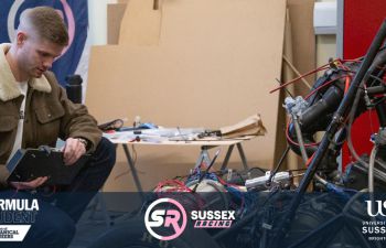A student working on some technical equipment in a workshop