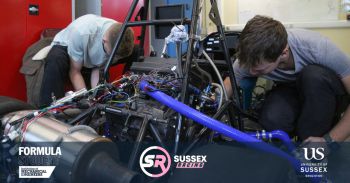 Students working on some technical equipment in a workshop