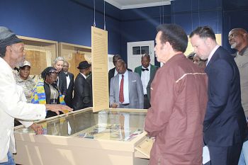 Khama III Memorial Museum’s Scobie Lekhutile explains the new display to guests at the official launch, including Kgosi Kgolo Khama IV (former President Ian Khama) and the UK High Commissioner, alongside JoAnn McGregor (Credit: Dr Keletso Gaone Setlhabi).