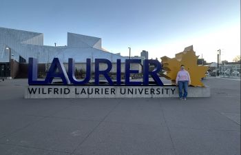 Kristabel standing in front of the Wilfrid Laurier sign