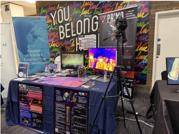 A stand at the event with various equipment and a banner reading 'Faculty of Science, Engineering and Medicine'