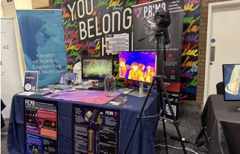 A stand at the event with various equipment and a banner reading 'Faculty of Science, Engineering and Medicine'