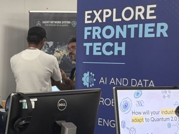 Two people talking next to a banner reading 'Explore Frontier Tech'