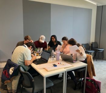 Group of diverse students working in a group sat at a table