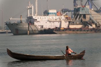 Small fishing boat in front of large boat