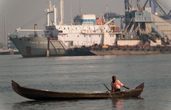 Small fishing boat in front of large boat