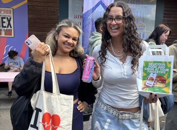 Two students holding up their free food at welcome week