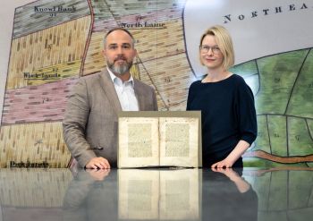 Dr Katie Walter and Dr James Wade in The Keep archive, Brighton, with the fragment of Nicholas Love’s early 15th-century Mirror of the Blessed Life of Jesus Christ