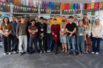 Large group of people including Dr Caroline Lucas, academics and Brighton-based sixth form students