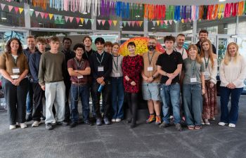 Large group of people including Dr Caroline Lucas, academics and Brighton-based sixth form students
