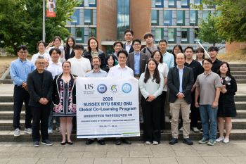 HYU GNU and SKKU university students and faculty from Korea pose with SPRU faculty outside of University of Sussex Business School