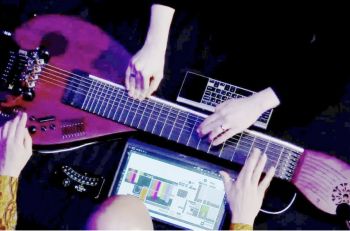 guitar and hands on a table with a keyboard