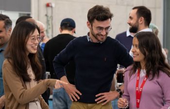 A photo of three students networking and smiling in a group setting at an Entrepreneurship event