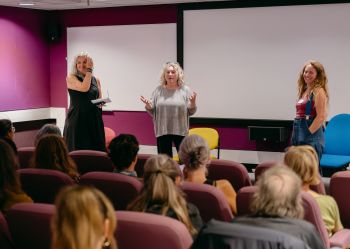 Kath Burton, Collette Haynes and Rachael Durrant taking part in a Q&A in the Silverstone cinema room, facing a seated audience after the film screening.
