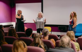 Kath Burton, Collette Haynes and Rachael Durrant taking part in a Q&A in the Silverstone cinema room, facing a seated audience after the film screening.
