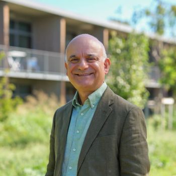 Dr Kamran Matin outdoors at Aix-Marseille University’s Institute for Advanced Study on a sunny day
