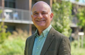 Dr Kamran Matin outdoors at Aix-Marseille University’s Institute for Advanced Study on a sunny day