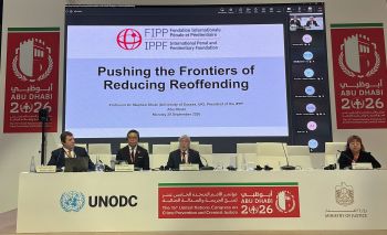 Prof Shute is shown seated in front of the title slide of his presentation