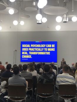 Academic speaker Jules Gillard presents research at the Boys Impact Hub launch in front of attendees.