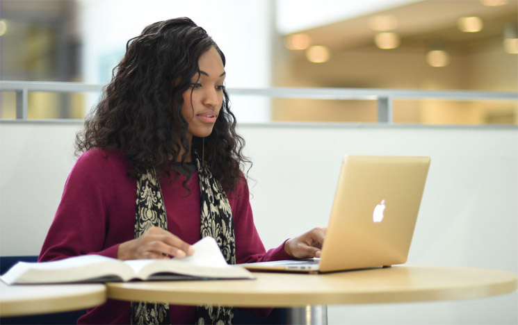 A student looking at their laptop