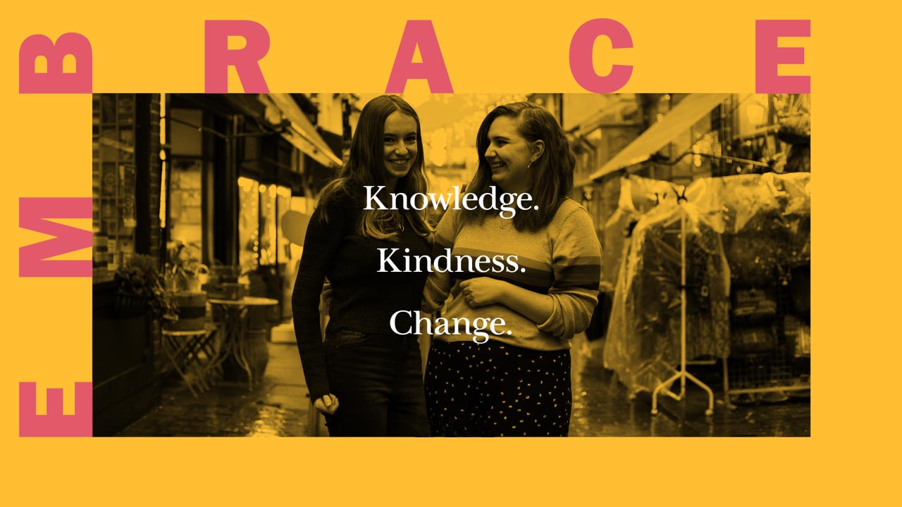 Friends Olivia and Jessica, behind the text 'Embrace knowledge; Embrace kindness; Embrace change'