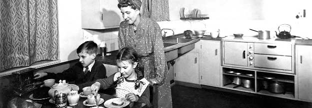 Mother and children in the kitchen - 1940s