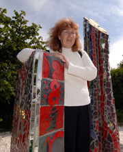 Jannet Cook with the Gaudi-inspired sculpture Fairway Flame, in Moulsecoomb, Brighton