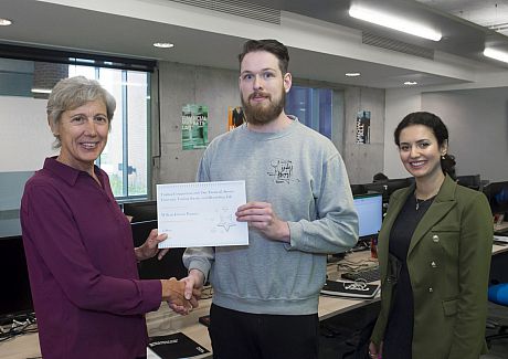 William Jobson Pargeter, winner of the financial trading competition, receives his certificate from Sue Newell and Madina Tash