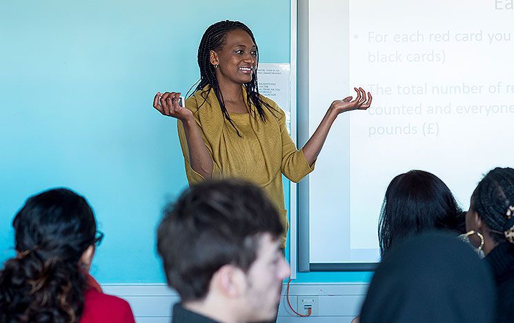 A woman leads a seminar for students