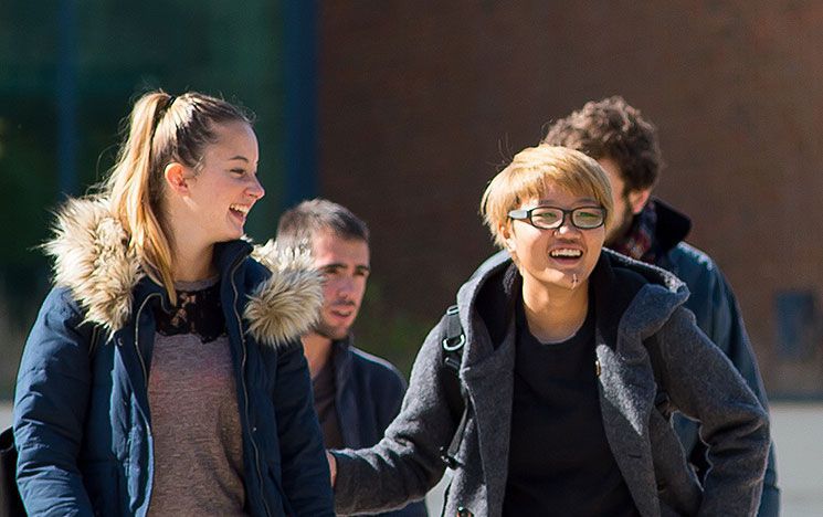 Some undergraduate students outside Jubilee in the sun