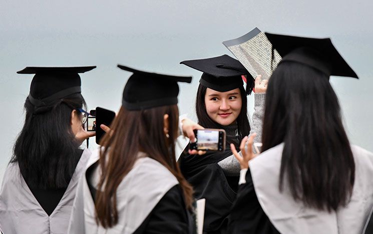 graduates celebrating on Brighton Beach