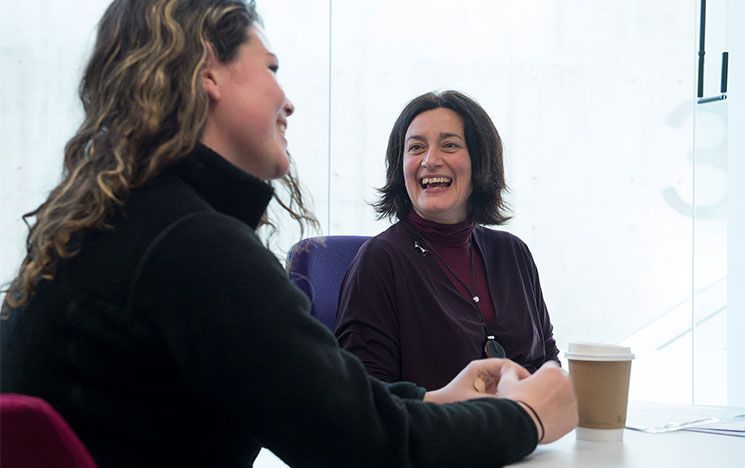 a lecturer speaks with a student